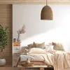 A bedroom scene with a bed, nightstand, and plant. Podgląd zdjęcia produktu