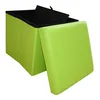 A green storage ottoman with its lid open, showing the black interior. Produktbild-Vorschau