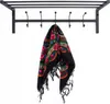 A black metal coat rack with hooks, with a colorful scarf hanging from one of the hooks. Produktbild-Vorschau