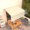 A balcony with a table, chairs, and a grill under a retractable awning. Produktbild-Vorschau