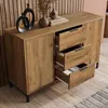 A wooden sideboard with drawers and doors, decorated with vases and books, in a room with wooden paneling. Anteprima dell’immagine prodotto