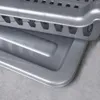 Close-up of two silver plastic trays stacked on a gray textured surface. Produktbild-Vorschau