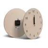 Two wooden clocks are shown against a white background. One clock is facing forward with its hands visible, while the other is turned to show its back with the clock mechanism. Produktbild-Vorschau