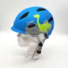 A blue children's helmet with a dinosaur design, displayed on a white bust against a white background. Produktbild-Vorschau