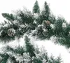 Close-up of a Christmas garland with pine cones and artificial snow. Produktbild-Vorschau