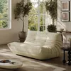 A modern living room with a beige sofa, large windows, and plants. Anteprima dell’immagine prodotto