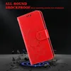 A red phone case with a floral design is shown against a dark background with debris. Produktbild-Vorschau