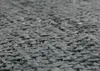 A close-up, low-angle shot of a textured gray surface, likely a fabric or material. Produktbild-Vorschau