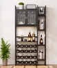 A tall, black, multi-tiered wine rack with glass doors and shelves, holding wine bottles, glasses, books, and decorative items. A potted plant is on the left. Anteprima dell’immagine prodotto