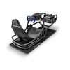 A racing simulator seat with a steering wheel and pedals, shown on a black mat. Produktbild-Vorschau
