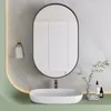 A modern bathroom vanity with a sink, mirror, and shelf. Produktbild-Vorschau