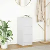 A white three-drawer cabinet is shown in a room with a plant and a coat rack. Podgląd zdjęcia produktu