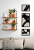 A living room scene with shelves displaying plants and artwork, and a sofa with pillows in the foreground. Produktbild-Vorschau