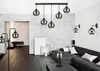 A modern living room with multiple light fixtures, including a ceiling pendant light and wall sconces, illuminating a sofa and coffee table. Náhled obrázku produktu