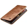 A brown leather flip case for a smartphone is shown on a white background. Produktbild-Vorschau