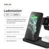 A black wireless charging station with a phone, smartwatch, and earbuds charging. Produktbild-Vorschau