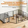 A dog pen setup with a dog bed and food bowls, connected to a dog crate. Podgląd zdjęcia produktu