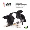 A dog is chewing on a treat, with marketing text and logos in the background. Produktbild-Vorschau