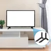A TV stand with a TV on it, and a close-up of the TV stand feet. Náhled obrázku produktu