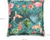 A cushion with a tropical print featuring flamingos and flowers. Produktbild-Vorschau