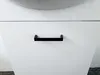 A close-up view of a white cabinet with a black handle. Podgląd zdjęcia produktu