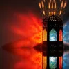 A decorative lantern casting colorful light patterns on a wall and its reflection. Náhled obrázku produktu
