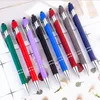 A collection of colorful pens arranged diagonally on a white and light gray grid background. Produktbild-Vorschau