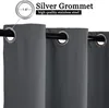 Close-up of dark gray curtains with silver grommets hanging on a black curtain rod. Produktbild-Vorschau