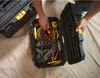 A person is organizing tools in a black Stanley modular toolbox. Voir les images du produit
