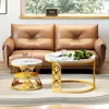 A living room scene with a leather couch and two modern coffee tables. Produktbild-Vorschau