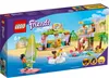 The image shows the packaging of a LEGO Friends Surf School playset, depicting the assembled toy on a beach and in the water with minifigures. Podgląd zdjęcia produktu