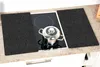 Two black cutting boards are placed on a kitchen countertop next to a stovetop with a pot on it. Produktbild-Vorschau