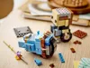 Two LEGO BrickHeadz figures are assembled on a wooden table, with some loose LEGO bricks scattered around. Náhled obrázku produktu