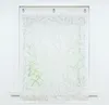 A white window with a sheer curtain featuring a branch pattern. Produktbild-Vorschau