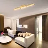 A modern living room with a piano, two sofas, and a coffee table, illuminated by a ceiling light. Produktbild-Vorschau