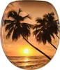 A toilet seat with a tropical sunset scene featuring palm trees and the ocean. Náhled obrázku produktu