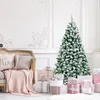 A decorated Christmas tree with presents underneath, next to a sofa with pillows and a blanket. Produktbild-Vorschau