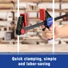 A hand holding a clamp in a workshop setting. Voir les images du produit