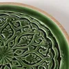 Close-up of a decorative plate with a carved pattern. Produktbild-Vorschau