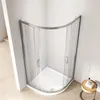 A modern corner shower enclosure with a curved sliding door, set against a plain white wall and light wood-effect flooring. Produktbild-Vorschau