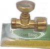 A brass gas shut-off valve with a gauge, packaged in clear plastic on a cardboard backing with German text. Produktbild-Vorschau