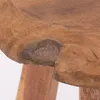 A close-up view of the textured surface and knot of a wooden stool. Produktbild-Vorschau