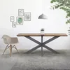 A dining table with a spider cross base and a chair in a room with wall art. Podgląd zdjęcia produktu
