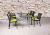 An outdoor dining set with chairs and tables against a stone wall. Produktbild-Vorschau