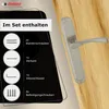A door handle set is shown on a wooden door, with a black overlay detailing the included components. Produktbild-Vorschau