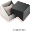 An open watch box with a cushion inside, and the lid placed next to it. Produktbild-Vorschau