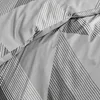 A close-up view of a gray duvet cover with a geometric pattern of white and black stripes. Produktbild-Vorschau