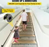 A man and a child are walking up a staircase with a black handrail installed along the side. Náhled obrázku produktu