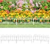 A white plastic garden border fence in front of a flower bed. Produktbild-Vorschau