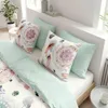 A neatly made bed with decorative pillows and bedding. Produktbild-Vorschau